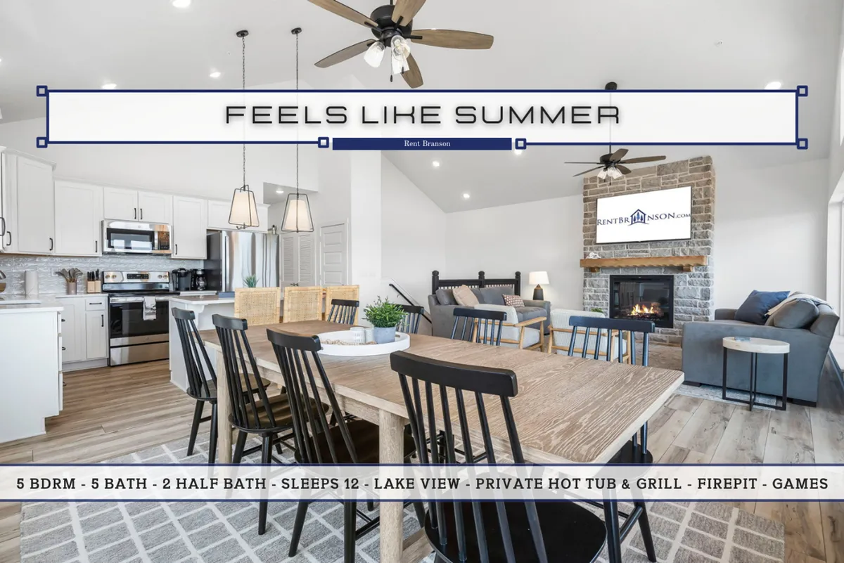 An open-plan space where the dining table, fireplace, kitchen area, and large windows with lake views seamlessly connect. Family and friends are invited to gather for meals, play games, or simply enjoy the scenery.